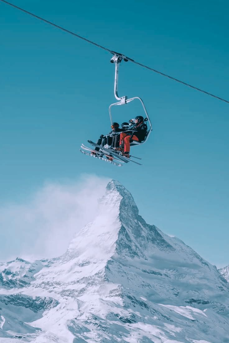 Esquiadores en una aerosilla sobre la montaña