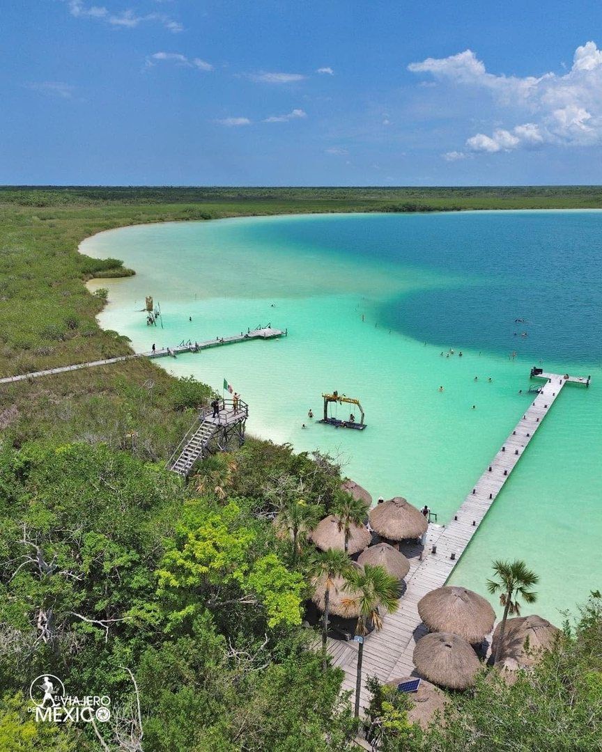 Laguna turquesa con muelle y palapas